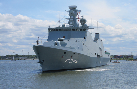 Large naval warship with F342 marking sailing on a calm, sunny day.