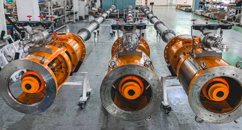 Industrial facility with large orange DESMI pumps for fluid handling applications.