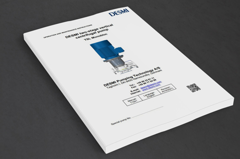 DESMI instruction manual for TBL MonoBloc centrifugal pump on a gray surface.